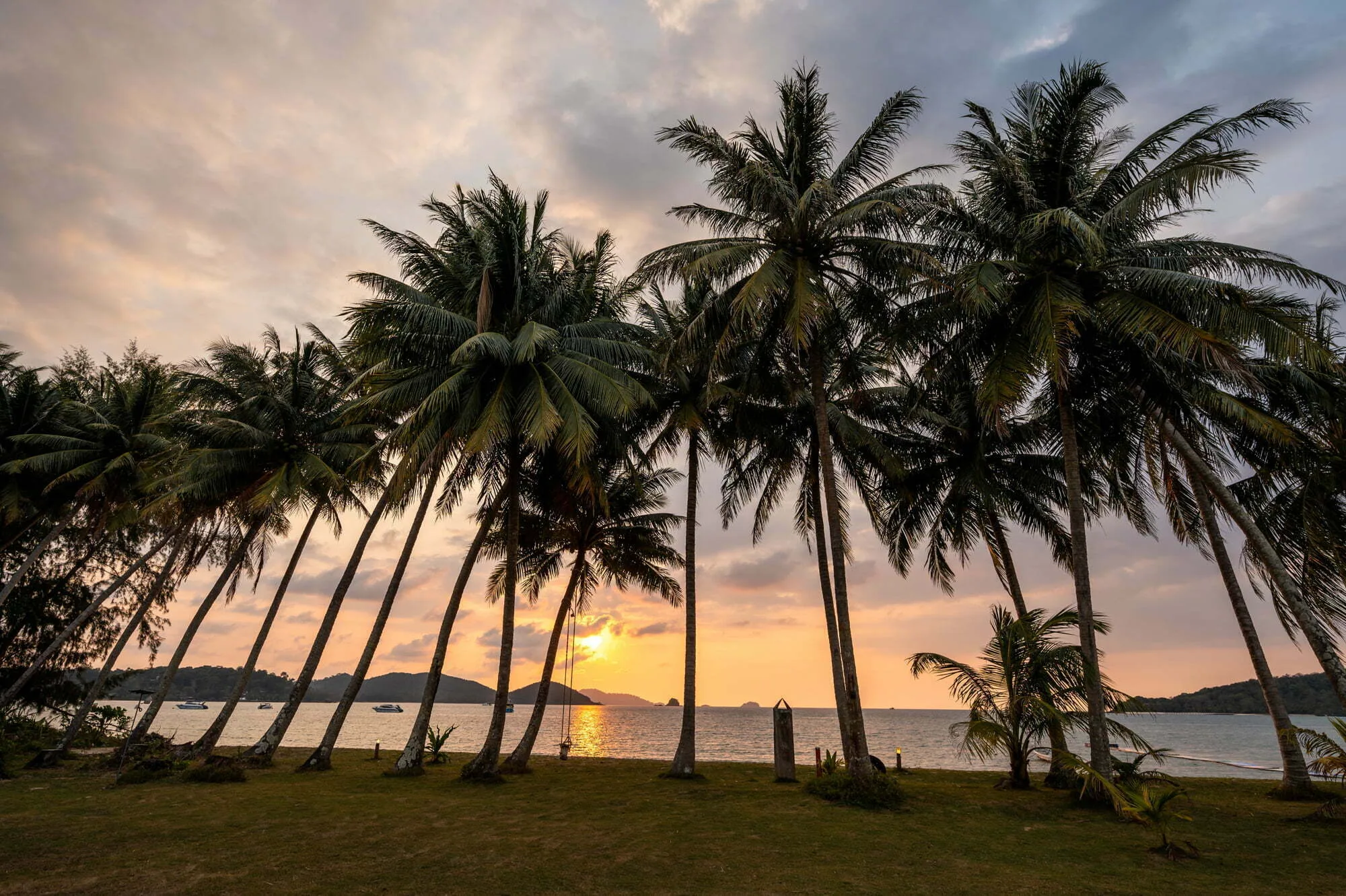Palmen bei Sonnenuntergang am Strand des Happys Days Resort auf Koh Mak