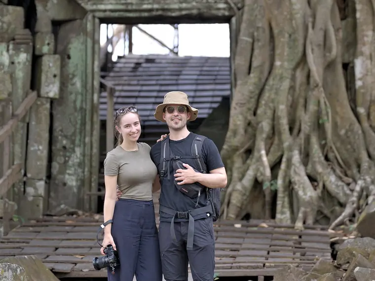 Vanessa und Alex vor einem Tor mit Baumwurzeln im Tempel Preah Khan Kampong Svay in Kambodscha